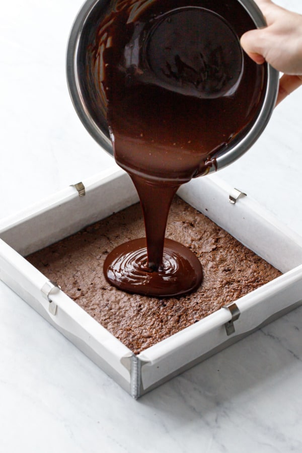 How to make brownie ice cream sandwiches: pour ganache into an even layer on top of brownie.