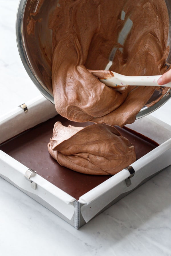 How to make brownie ice cream sandwiches: once ganache is set, top with no-churn cocoa ice cream.