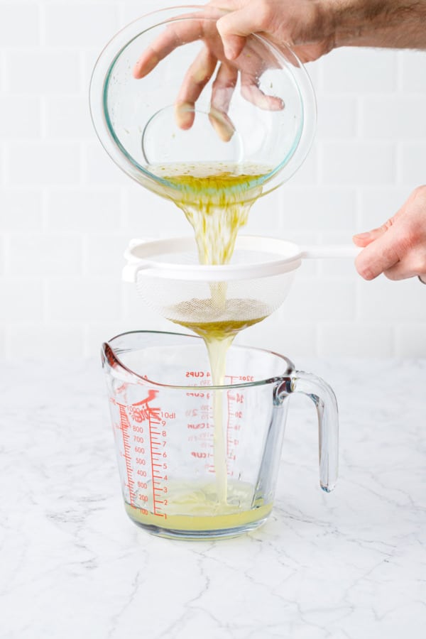 After a 24-hour rest, strain the lime cordial through a fine mesh strainer to remove zest.
