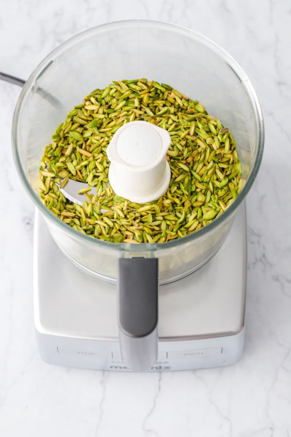 Food processor with slivered pistachios, before processing for Homemade Pistachio Butter.