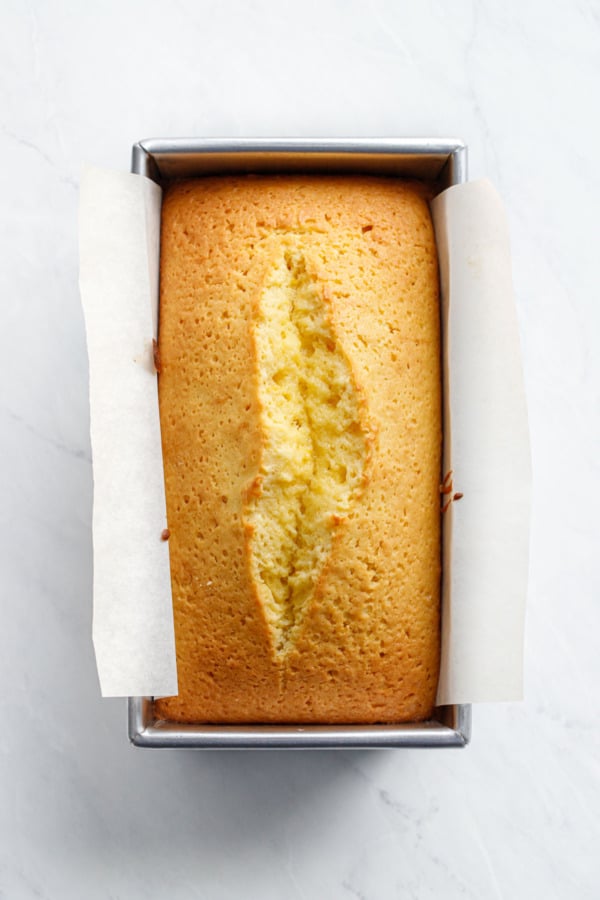 Overhead, Meyer Lemon Olive Oil Loaf Cake after baking, showing a beautifully defined crack right down the center.