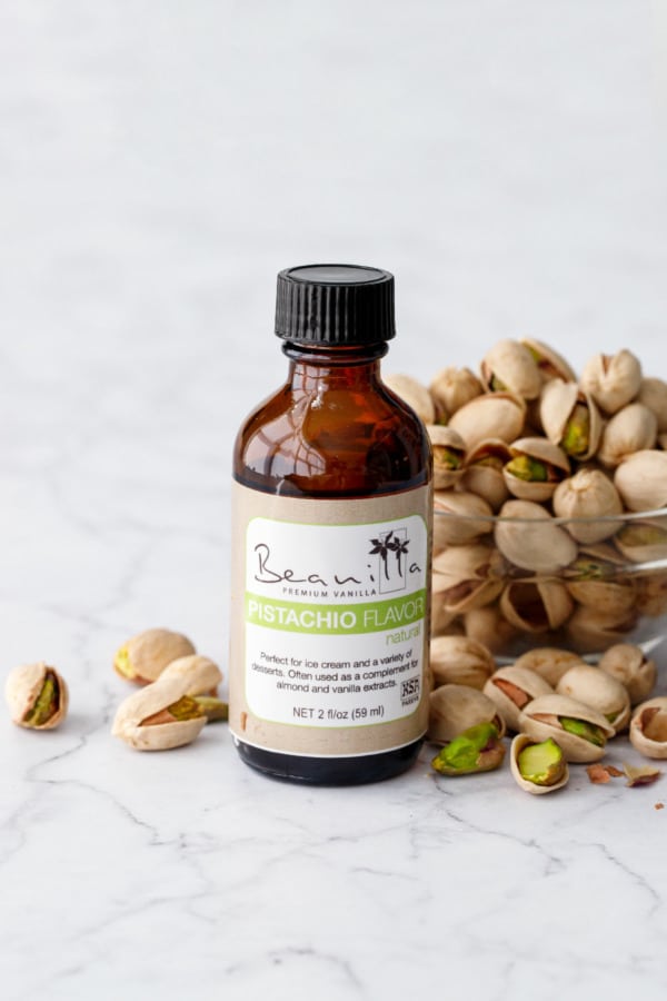 Beanilla Pistachio Extract bottle with bowl of pistachios.