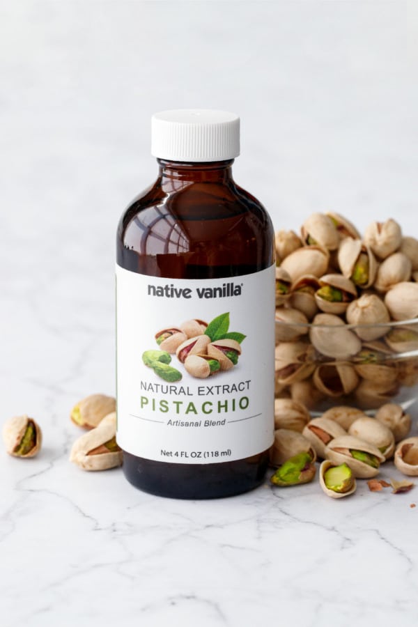 Native Vanilla Pistachio Extract bottle with bowl of pistachios.