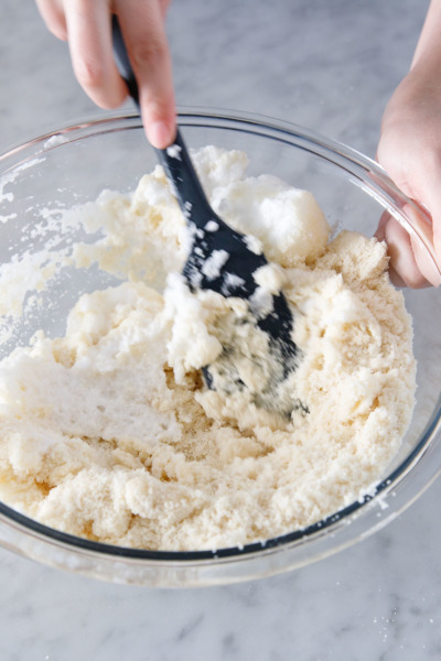 How to make Amaretti Morbidi cookies: mix beaten egg whites into almond flour and sugar.