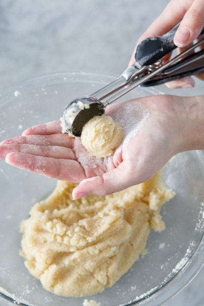 How to make Amaretti Morbidi cookies: use a cookie scoop to form evenly sized balls of dough